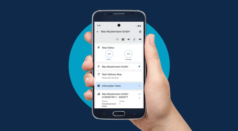 A hand holds a smartphone displaying delivery information for Max Mustermann GmbH, showing stop status and package details.